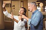 Businesswoman gesturing while explaining colleague