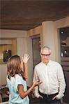 Businesswoman gesturing while discussion with colleague