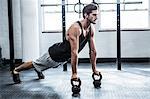 Fit man working out with kettlebells
