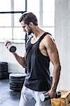 Fit man working out with dumbbell