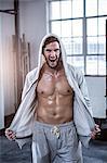 Fit shirtless man with hooded jumper