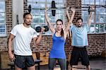 Fit people lifting weights together