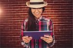 Attractive hipster holding her tablet