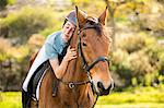 Happy woman riding her horse