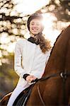 Young woman riding her horse