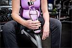 Pregnant woman holding water bottle