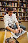 Student in wheelchair typing on his laptop