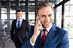 Portrait of smiling businessman having a phone call