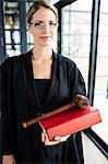 Female lawyer holding her book and her hammer