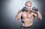 Composite image of portrait of bald muscular man