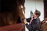 Pretty woman taking care of her horse