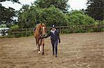 Female rider leading her horse