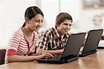 A group of students in class, using a digital tablet