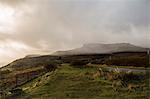 Mist over mountains and a road through a remote landscape.