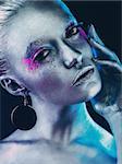 Aluminium girl with smoke, pink and purple eyeshadows makeup mua on dark black background