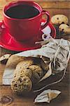 cup of coffee and oatmeal cookies with chocolate on the wooden table. background. vertical. toning