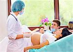 doctor consulting patients on partner childbirth