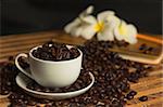 cup filled with coffee beans in the background flower