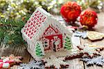 Christmas gingerbread house on a background of festive decorations.