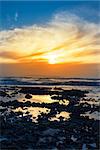 reflections at rocky beal beach near ballybunion on the wild atlantic way ireland with a beautiful yellow sunset