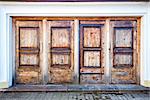 Row of four wooden doors in a wall