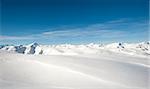 Panoramic view over a snow covered mountain range in the alps