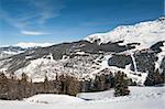 Panoramic view of a snow covered mountain range looking down valley