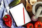 Fresh vegetables and blank recipe book