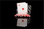 Poker cards on black background with reflexion