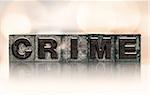 The word "CRIME" written in vintage ink stained letterpress type.
