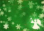 Horizontal grunge Christmas background of green color with snowflakes, angel  and paper texture