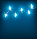 White led Christmas lights garland on blue background