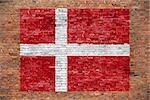 Flag of Denmark painted on old brick wall