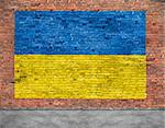 Flag of Ukraine painted over aged brick wall