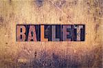 The word "Ballet" written in dirty vintage letterpress type on a aged wooden background.