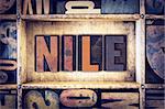 The word "Nile" written in vintage wooden letterpress type.