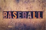 The word "Baseball" written in dirty vintage letterpress type on a aged wooden background.