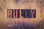 The word "Bully" written in dirty vintage letterpress type on a aged wooden background.