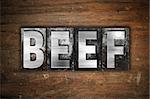 The word "Beef" written in vintage metal letterpress type on an aged wooden background.