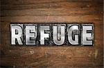 The word "Refuge" written in vintage metal letterpress type on an aged wooden background.