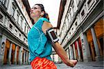 Now it is time to invest in your body and no matter you are at hometown or traveling. Female in sports outfit is stretching to start outdoors workout next to Uffizi gallery in Florence Italy