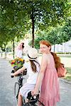 Mother and daughter riding bicycle