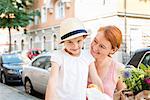 Portrait of mother with daughter in city