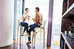 Couple in apartment having a coffee break