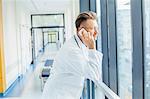 Doctor in medical clinic using mobile phone