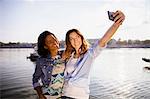 Two women making a selfie with smart phone