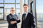 Portrait of two well-dressed businessmen in modern office