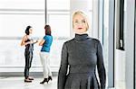 Portrait of female architect with colleagues in background