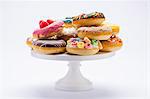 Various colourful doughnuts on a cake stand