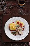 Roast pork roulade with potato gratin, apple stars and redcurrants